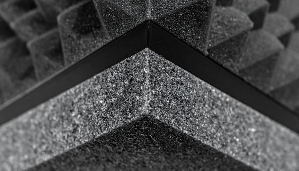 Acoustic felt baffle corner with crisp bevel mid gray field and top copy strip minimal interior material background for banner and modern layout photo