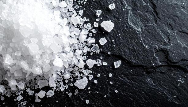 Sea salt flakes on black stone crisp highlights right side copy space representing culinary texture suitable for food photography branding and menus photo