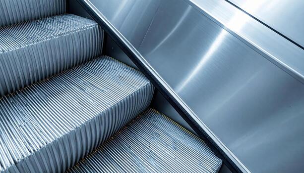 Escalator comb teeth abstract close up brushed metal with open upper copy space representing transport detail suitable for architecture industry and modern design photo