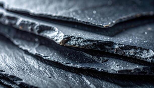 Slate cleavage sheets with powdery edge highlights cool graphite palette central copy space representing stone layers suitable for architecture decor and geology design photo