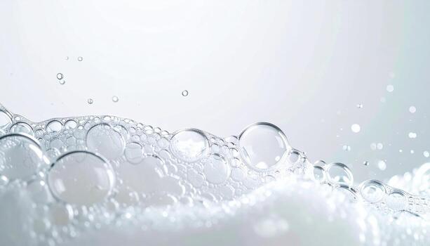 Soap lather microbubbles sliding on glass soft white top copy space representing clean hygiene texture suitable for beauty wellness packaging and product design photo