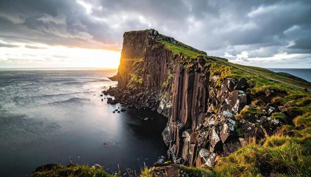 Basalt cliff edge last rim light above dark ocean dramatic scale representing powerful coastal geology and vertical grandeur suitable for adventure features editorial covers and seascape design photo