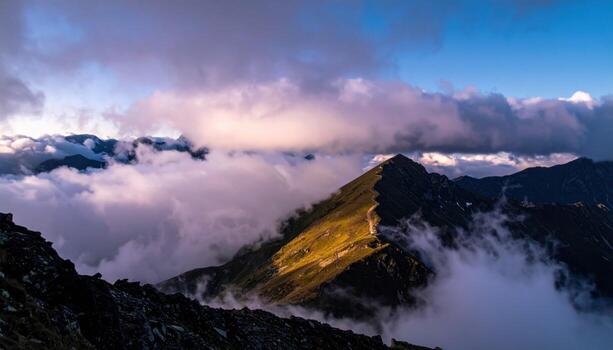 Cinematic mountain photo of a high pass col filled with cloud, saddle glowing from spill light while surrounding ridges fall nearly black for dramatic contrast.