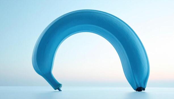 Blue java banana forming a gentle arc on a pale sky backdrop creamy cyan hue with soft horizonless fade ideal for editorial wellness and modern branding photo