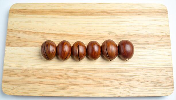 Jackfruit seed shells polished and spaced evenly on pale bamboo board refined botanical study for editorial education culinary and minimalist backgrounds photo