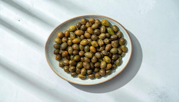 Papaya seed cluster arranged in a tidy oval on cool ceramic with low relief shadows refined tropical study for editorial cuisine and modern branding photo
