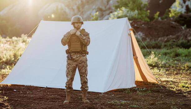 Fictional soldier adjusting helmet strap beside canvas tent soft side light unmarked uniform professional field portrait for training security preparedness and defense concept imagery photo