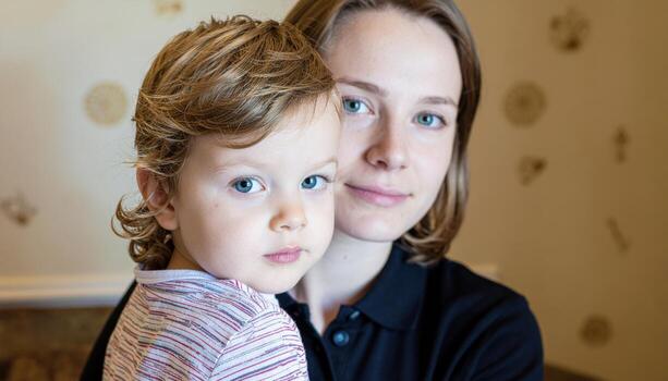 Young child conveying sincere compassion with steady eyes clamshell light on warm neutral set studio portrait for caregiving kindness and mental health concepts photo