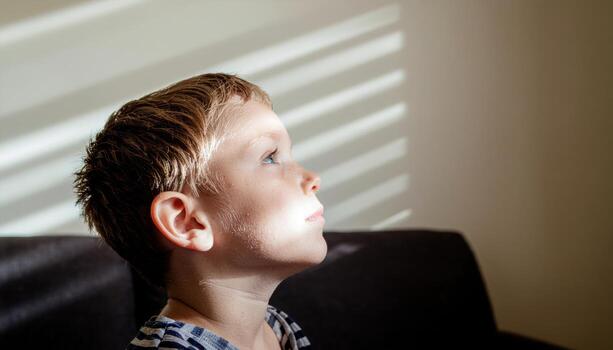 Young child in inventive daydream diagonals of projector texture neutral wall quiet atmosphere modern studio portrait for creativity learning and brand storytelling photo