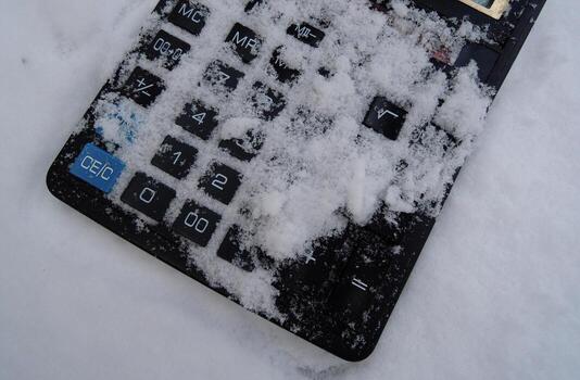 Powder Snow Covers The Front Panel With Square Buttons Of Rare Solar-Powered Calculator. Concept image for illustration of financial problem photo
