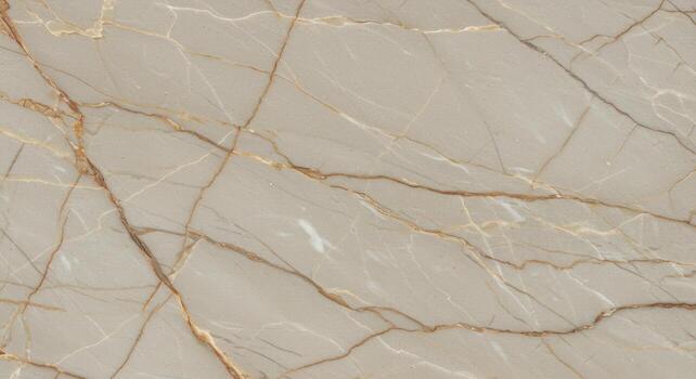 Elegant light beige marble surface with intricate golden vein patterns creates a luxurious and sophisticated texture for interior design and backgrounds. photo