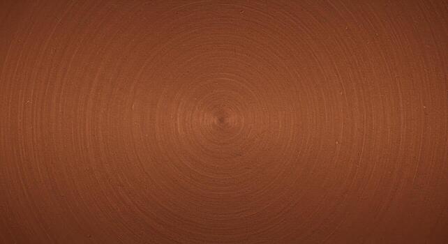 Circular texture background shows a smooth, elegant bronze surface with concentric s emanating from the center, creating a subtle and refined aesthetic appeal. photo