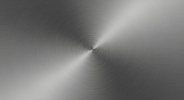 A circular brushed metal surface radiates from a central point, exhibiting a subtle gradient from light to dark, creating a modern industrial aesthetic look. photo