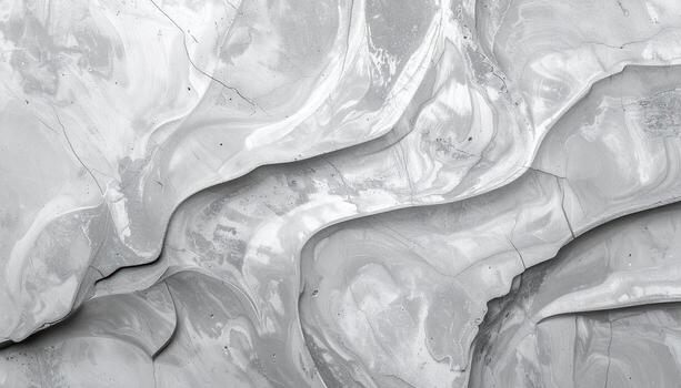 A monochrome textured surface displays swirling patterns and cracks, creating an abstract landscape with varying depths and a sense of artistic movement overall. photo