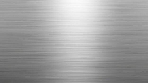 The brushed metal surface shows a subtle gradient of light from bright highlights to darker shadows, creating a sleek and modern industrial design element here. photo