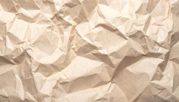 The full frame view showcases a textured surface of crumpled brown paper, creating an abstract pattern with highlights and shadows across its rugged terrain. photo