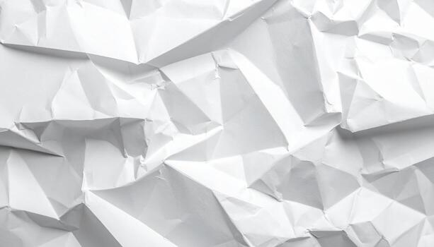 An abstract close up shot showcasing the texture of a crumpled white paper surface, creating a dynamic pattern with light and shadows on the wrinkled planes. photo