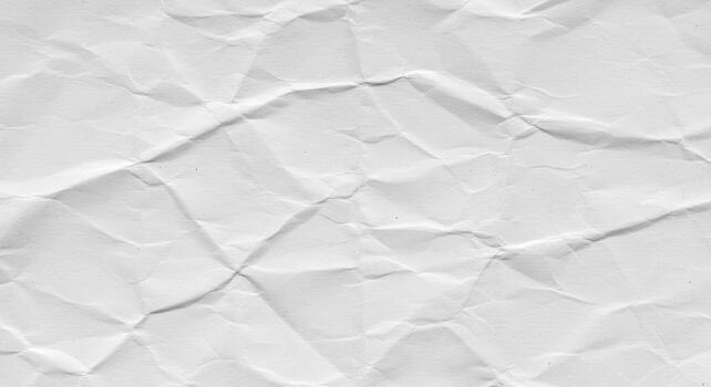 The textured surface of the crumpled white paper reveals a myriad of lines and shadows, creating a dynamic background with both depth and visual interest. photo