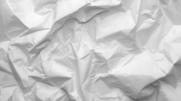 The crumpled white paper creates a textured abstract background showcasing light and shadows across its folds and ridges, perfect for artistic use in designs. photo