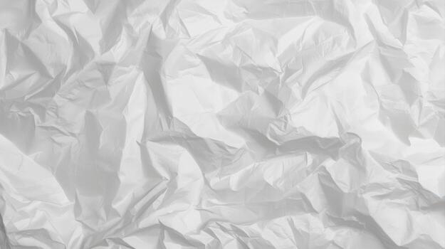 A textured white surface shows the light reflecting from the many random creases and folds of the wrinkled paper in a bright, clean, and simple scene. photo