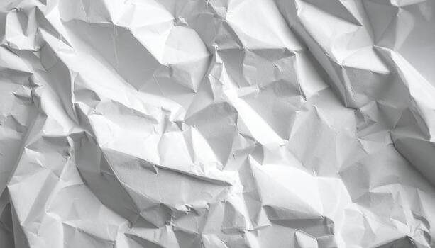 Detailed close up shows a crumpled white paper background, with interesting shadows and textures creating a pattern ideal for graphic designs or presentations. photo