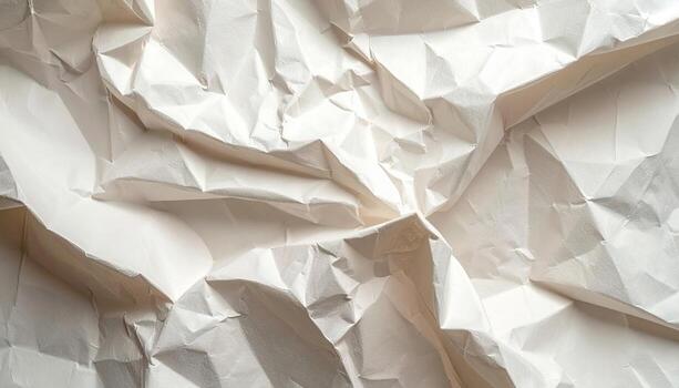 The textured surface of crumpled white paper creates intricate patterns of shadows and light, perfect for abstract backgrounds and artistic compositions. photo