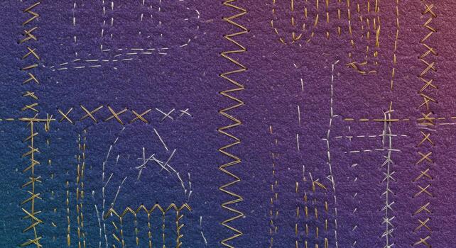 A close up macro photograph presents examples of various sewing machine stitches on a textured fabric surface showing artistic golden thread and purple colo. photo