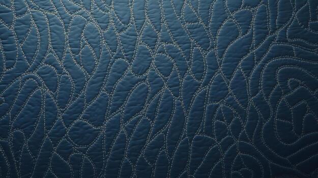 Intricate stitching creates an abstract pattern on the textured blue leather surface, offe a sophisticated backdrop for a variety of design applications. photo