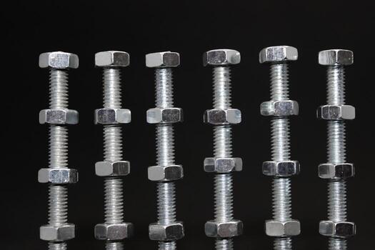 Steel Nuts At The Same Distance Between On A Long Threaded Metal Bars Texture Background photo