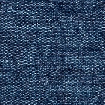 Close up shows an intricately woven blue fabric with a textured surface creating a visually interesting pattern. photo