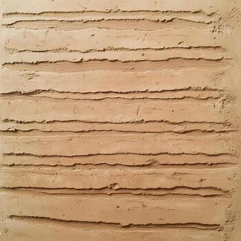 Horizontal textured lines are visible on tan plaster wall, creating a rough abstract background surface. photo