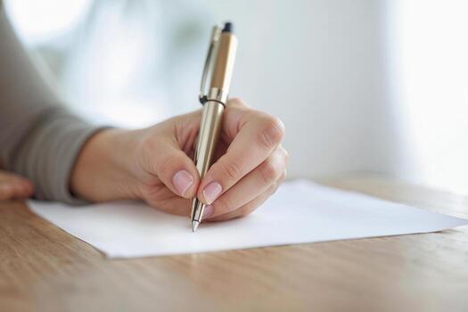 Hand of woman is writing with a pen on document. Conception signing an agreement photo