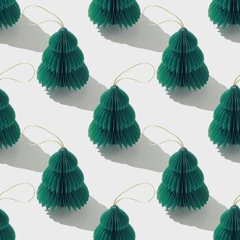 Top view of green honeycomb paper Christmas ornaments in minimal Seamless pattern on white. Stylized New Year fir trees decor. Festive Holiday Packaging Design, gift wrapping paper, textile design. photo
