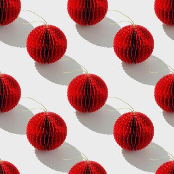 Top view of red honeycomb paper Christmas ornaments in minimal Seamless pattern on white. Bright New Year balls with sun shadows. Festive Holiday Packaging Design, gift wrapping paper, textile design. photo