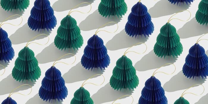 Top view of green blue honeycomb paper Christmas ornaments in minimal trend pattern on light background. New Year fir tree with sun shadows creating rhythmic, graphic banner modern holiday themes. photo