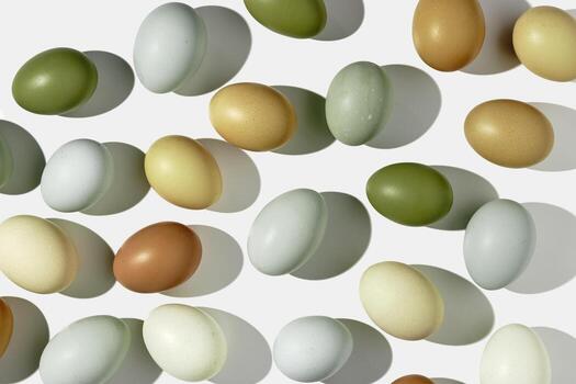 Natural eggs repeat pattern, green brown blue colored Chicken egg with shadow at sunlight, creative food layout. Minimal Easter holiday concept, top view still life, trend patterns, flat lay photo