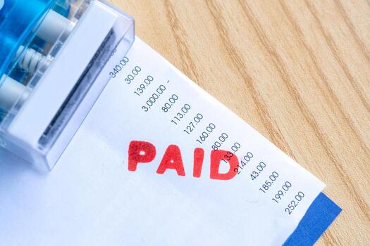 Red Paid Mark on Bill Invoice Paper with Numbers photo