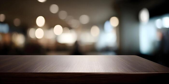 An empty dark wood table with a blurred background featuring warm bokeh lights perfect for product display photo