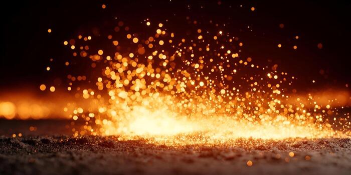 Bright fiery sparks erupt from the ground against a dark background creating a dynamic and energetic display photo