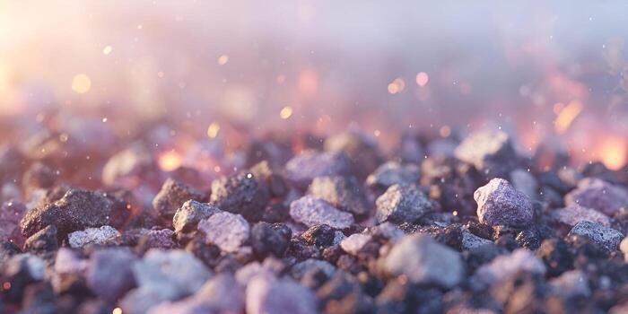 A close up of dark textured rocks illuminated by warm glowing light and sparkling dust particles creating an abstract background photo