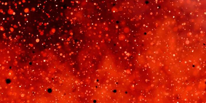 A vibrant red bokeh background with shimmering light particles creates a magical and festive abstract texture photo