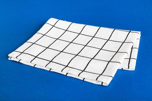 top view with white empty kitchen napkin isolated on table background. Folded cloth for mockup with copy space,Minimal style photo