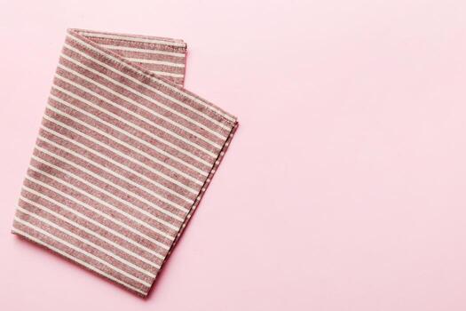 top view empty kitchen napkin isolated on table background. Folded cloth for mockup with copy space photo
