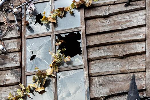 a window with a broken pane of glass and a broken window frame photo