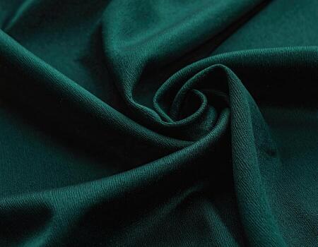 Deep teal fabric draped in swirling folds photo