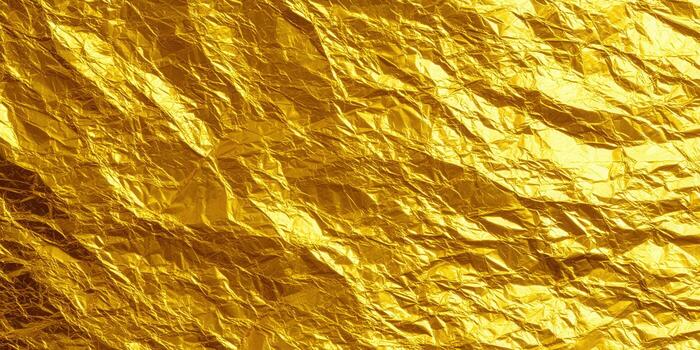 A detailed gold foil texture with folds and crumpled effect. photo
