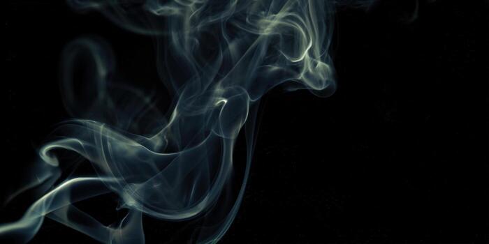 Abstract smoke gracefully dances against a deep black background, creating an enchanting visual. photo