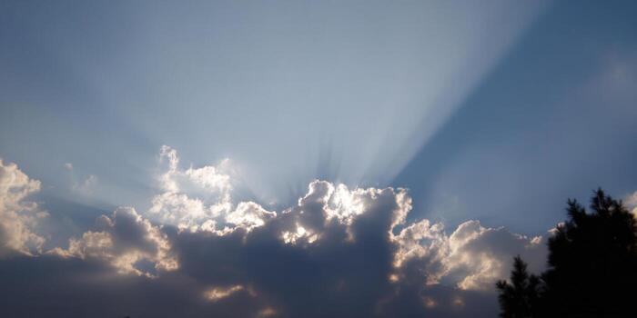 Sun rays breaking through clouds, creating a stunning and ethereal display in the sky. photo