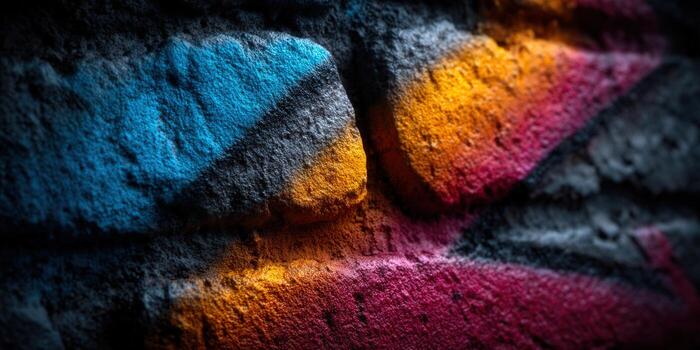 A close-up view of colorful graffiti painted on a weathered brick wall, showing vivid hues. photo