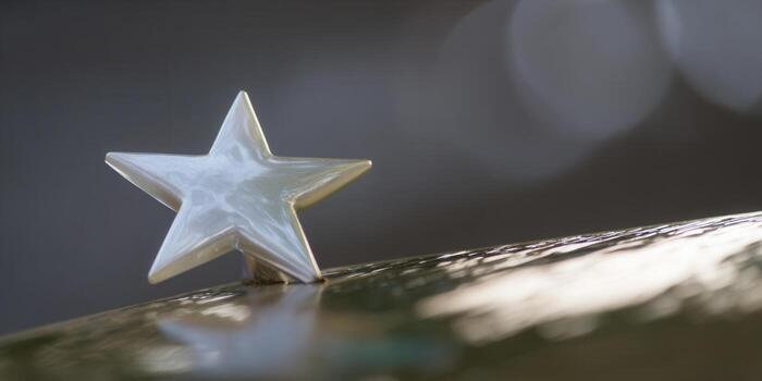 A shiny star ornament sits on a reflective surface, creating a beautiful scene. photo